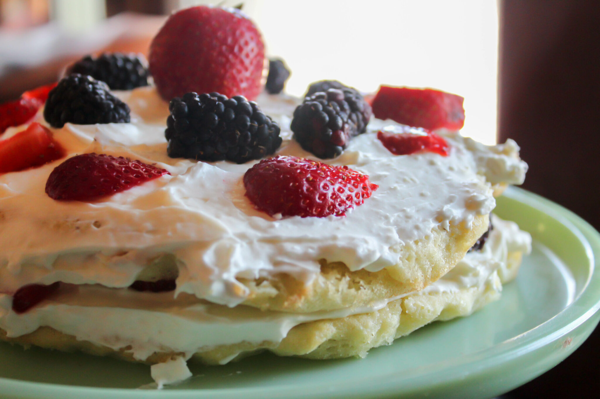 My Berries and Cream Cake is not only delicious but beautiful! It has two decadent layers stuffed with a cream cheese icing and berries! 